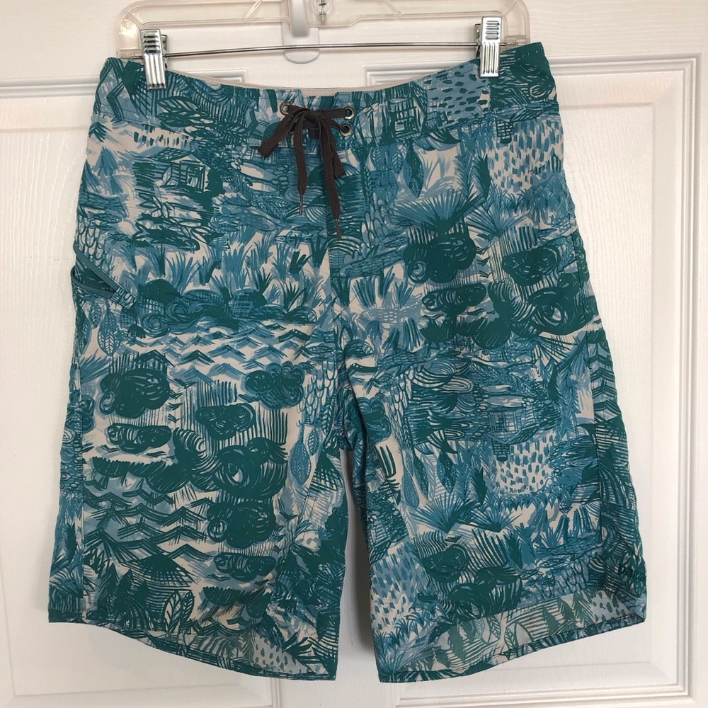 Patagonia Board Shorts lace up waist to fasten zip pocket at thigh. Teal print